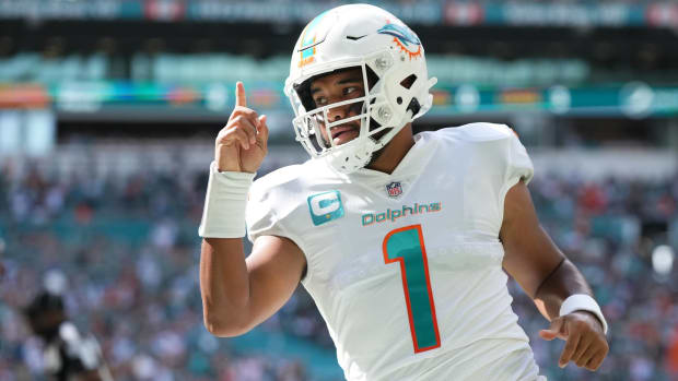 Dolphins quarterback Tua Tagovailoa celebrates a touchdown in a game.